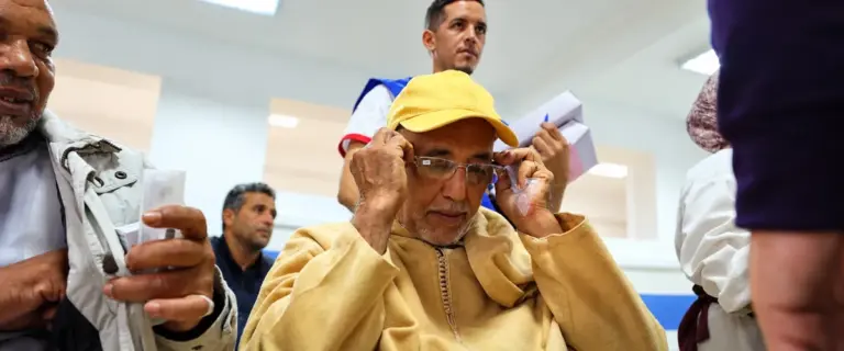 Elderly man trying on a new pair of eyeglasses