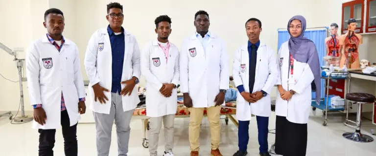 Eye-care trainees in white coats at a training institute